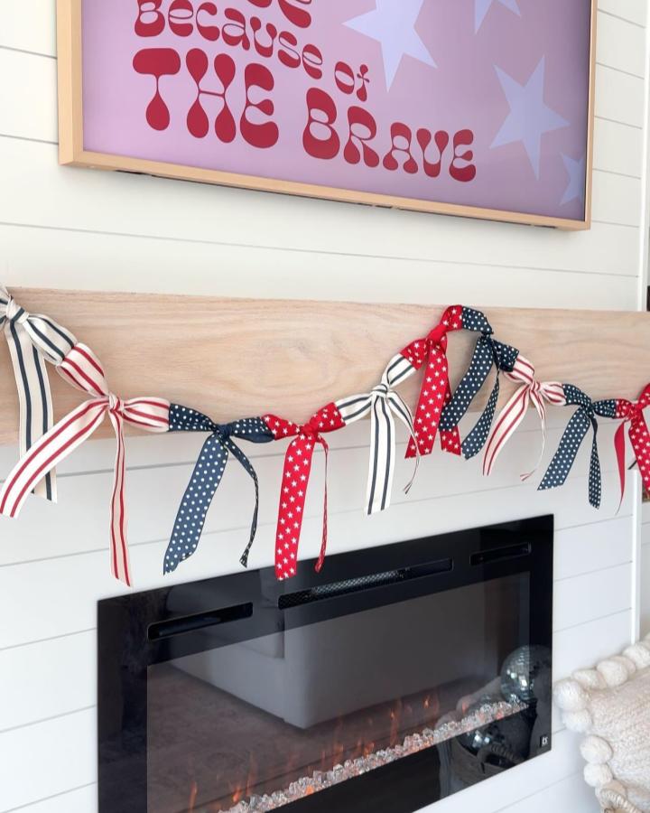 Red white and blue striped and patterned ribbon garland tied on wooden mantel from @michaelsstores, patriotic and festive home decor craft idea.