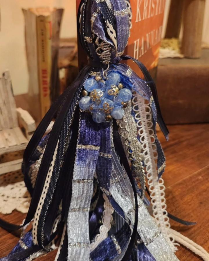 Navy and silver mixed ribbons with pale blue bead cluster decorative Bible tassel from @gracefullysavedtreasures on wood surface.