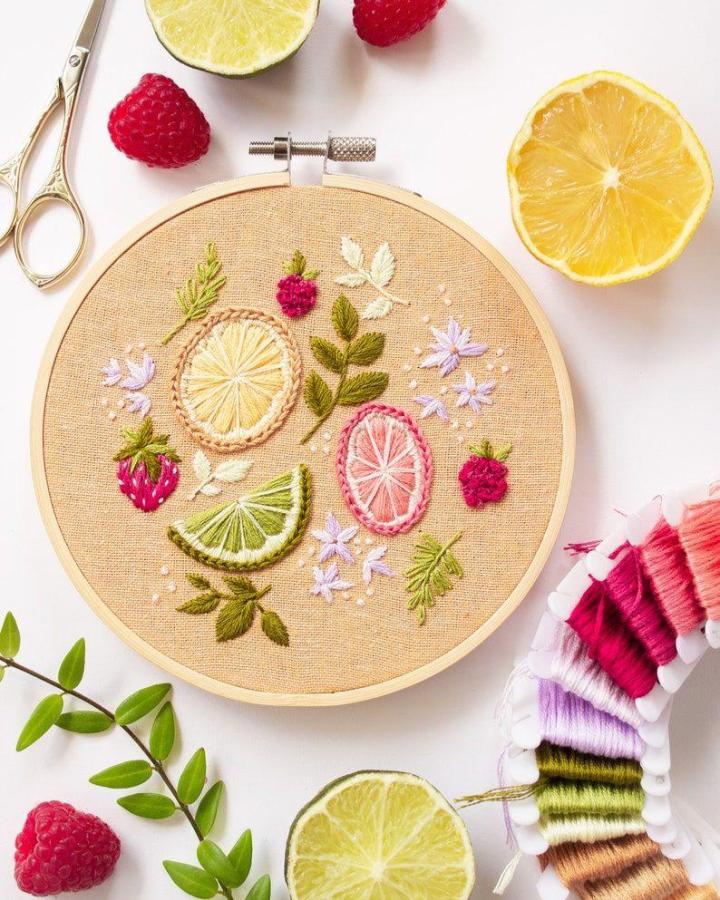 Bright colorful embroidered citrus and berries on linen hoop for summer crafts for adults by @byalyploof with floral accents and stitching floss