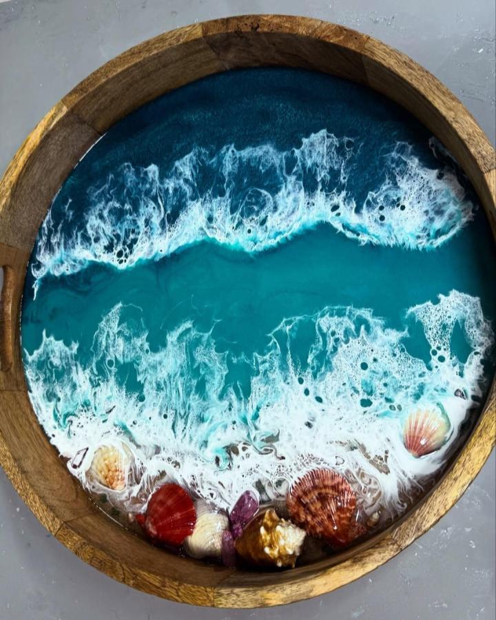 Ocean-inspired resin tray with seashells and foamy waves by @karenhammondart showing summer crafts for adults with coastal colors and textures.