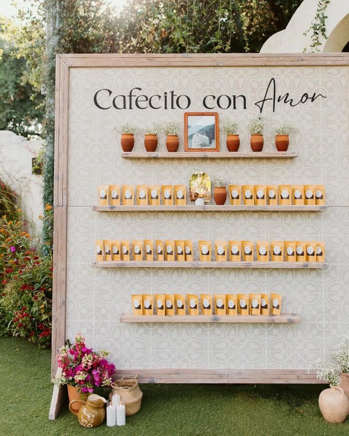 Rustic kraft coffee bean packs and terracotta pots wedding favor ideas from @tivoliweddings outdoor display with floral accents