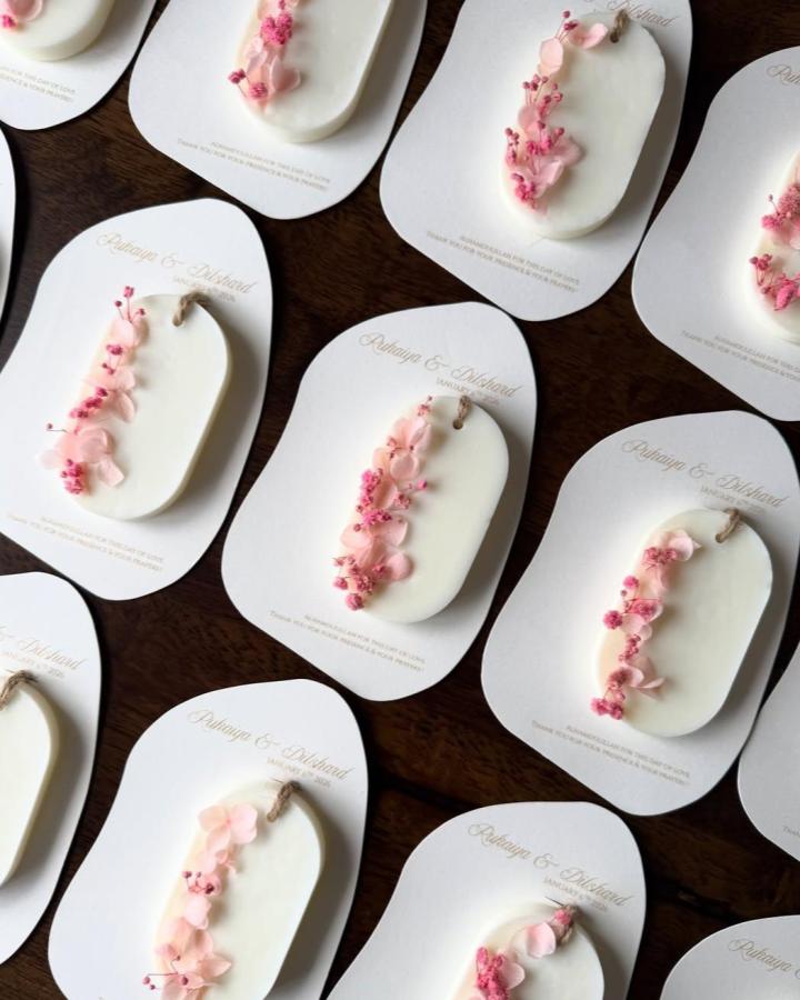 Soft white wax sachets decorated with pink dried florals from @wickwish_ perfect for wedding favor ideas.