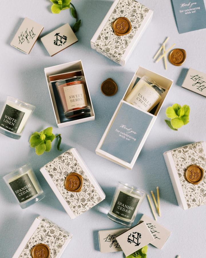 Cream and blue floral candle gift boxes with wax seal by @eros_stationery for wedding favor ideas, including scented candles and custom matchboxes.