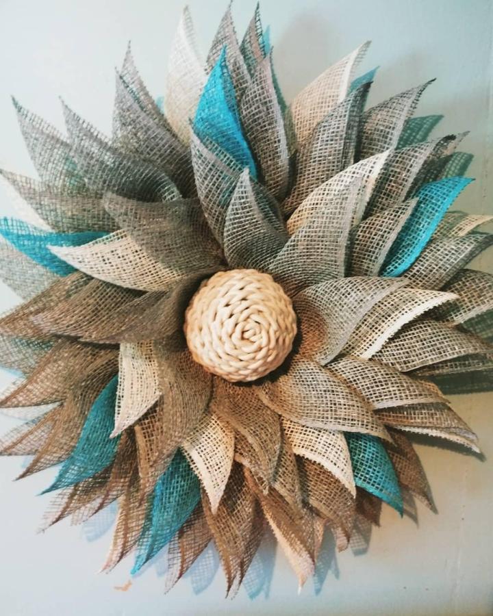 Natural burlap flower with teal highlights from @ttmanuel36 showing layered woven petals and a braided center detail.