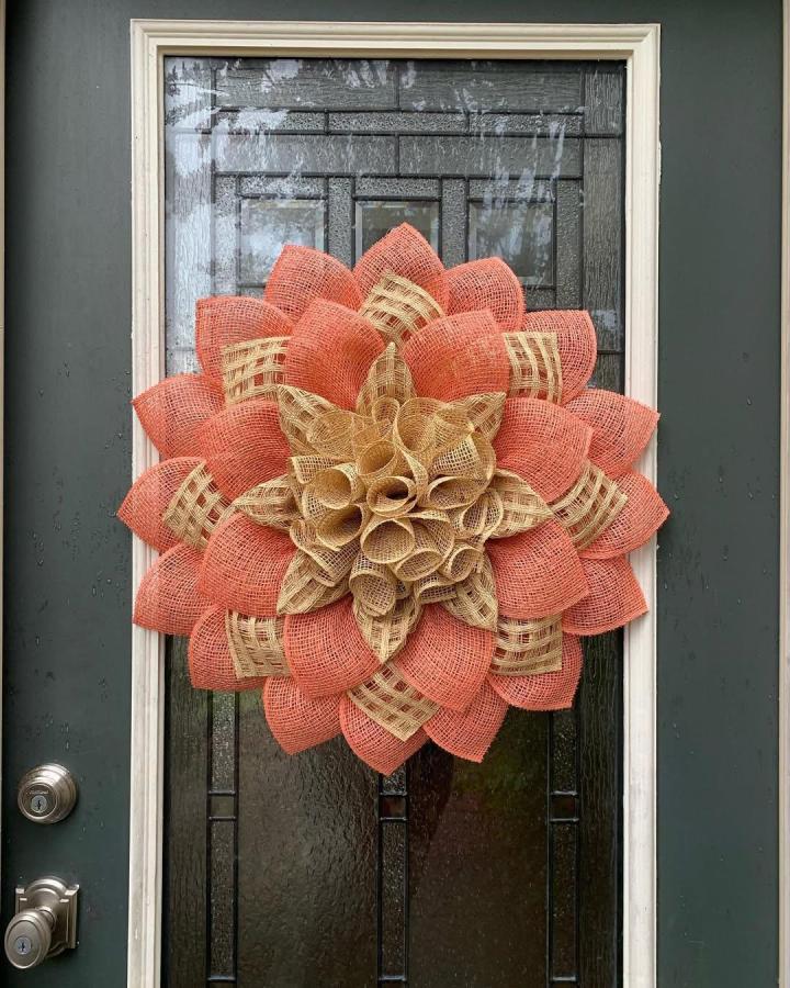 Coral and beige textured burlap wreath on glass door by @sentimentaldecor with layered curled petals handcrafted.