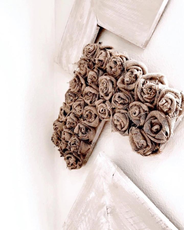Rustic burlap rose cluster wall decor from @therusticdesert. Handmade textured floral craft with natural tones.