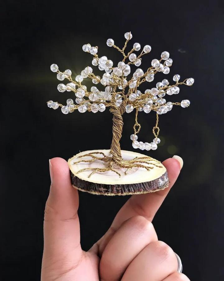 Copper wire crafts miniature tree with crystal beads on wood base by @cotzl_egypt delicate and artistic copper wire sculpture.