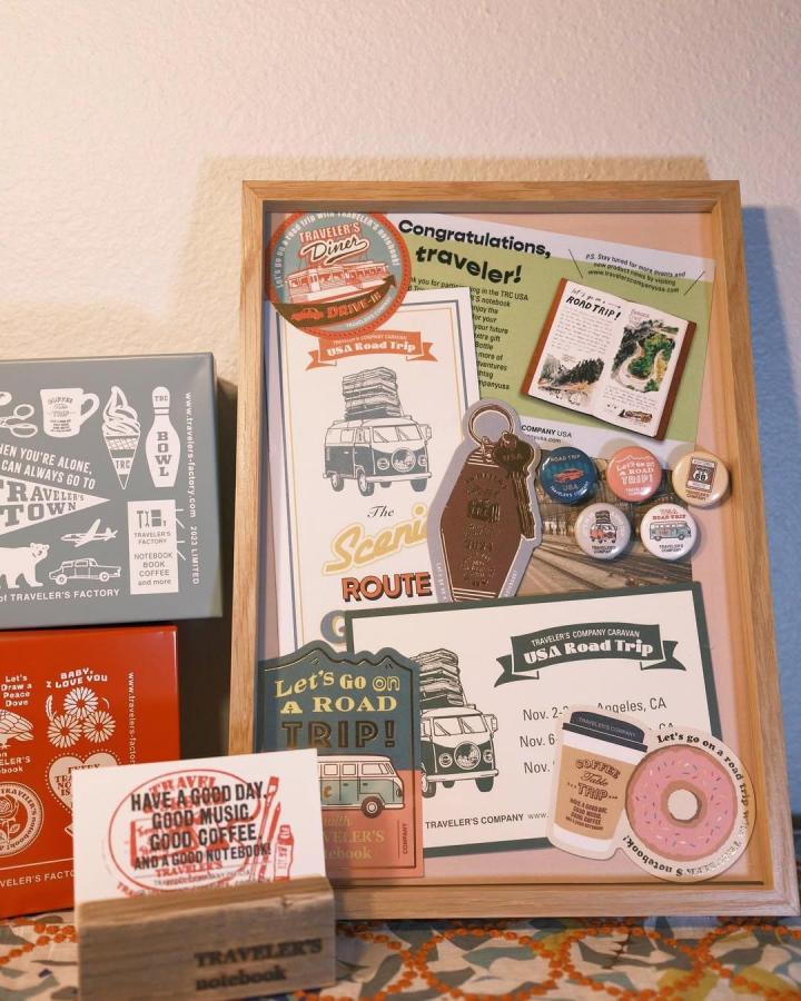Travel themed pastel cork board diy ideas by @traveler.zoe showcasing pins, postcards, and vintage road trip memorabilia in a wooden frame.