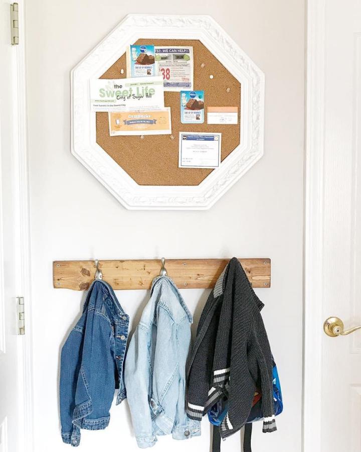 Vintage octagon cork board with white ornate frame in entryway from @thelatinanextdoor functional and decorative display.