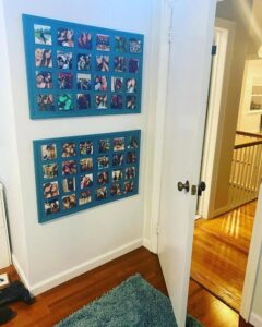 Teal painted cork board photo display wall from @lizzack4444 showing organized, colorful memory boards in a cozy home corner.