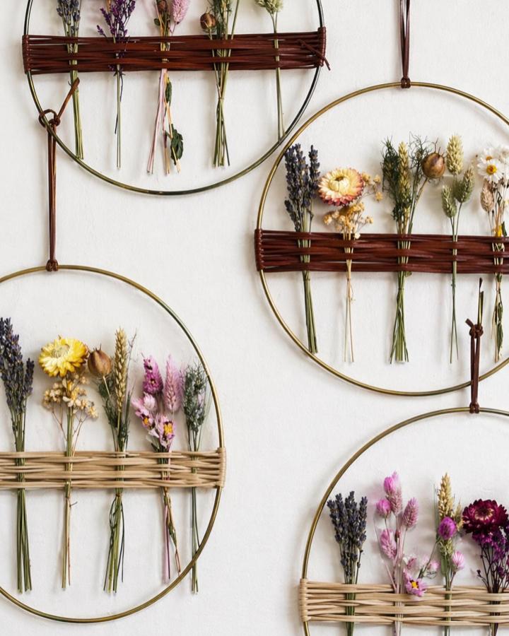 Gold hoop wall hanging with dried lavender, yellow and pink flowers from @bloomeon. Natural dried botanical display on woven rattan bands.