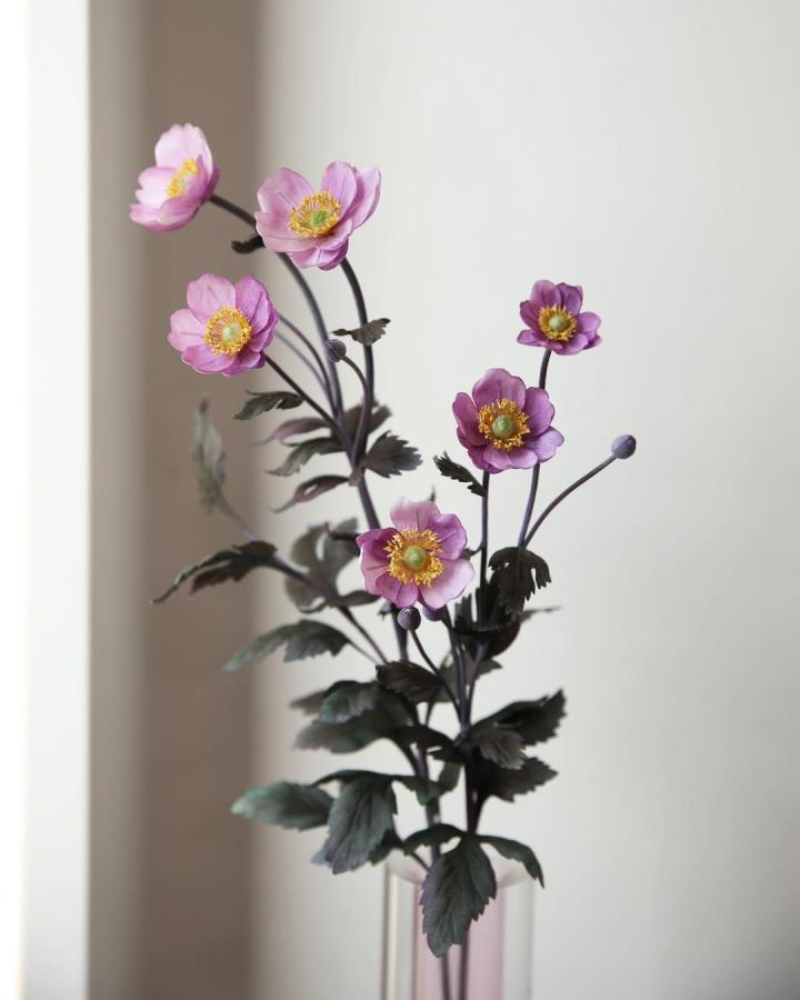 Soft purple fabric floral stems with yellow centers and dark green leaves by @sallysflower_official. Elegant and lifelike craft bouquet.