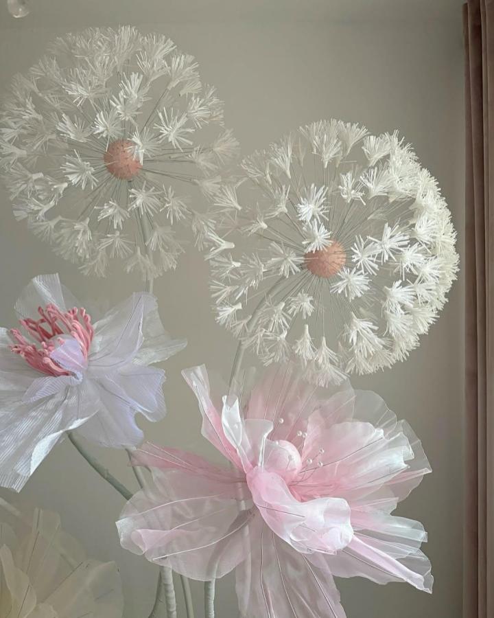 White and pink airy fabric flowers with wire stems and pearl accents from @anyblossom showing delicate, translucent petal craftwork.