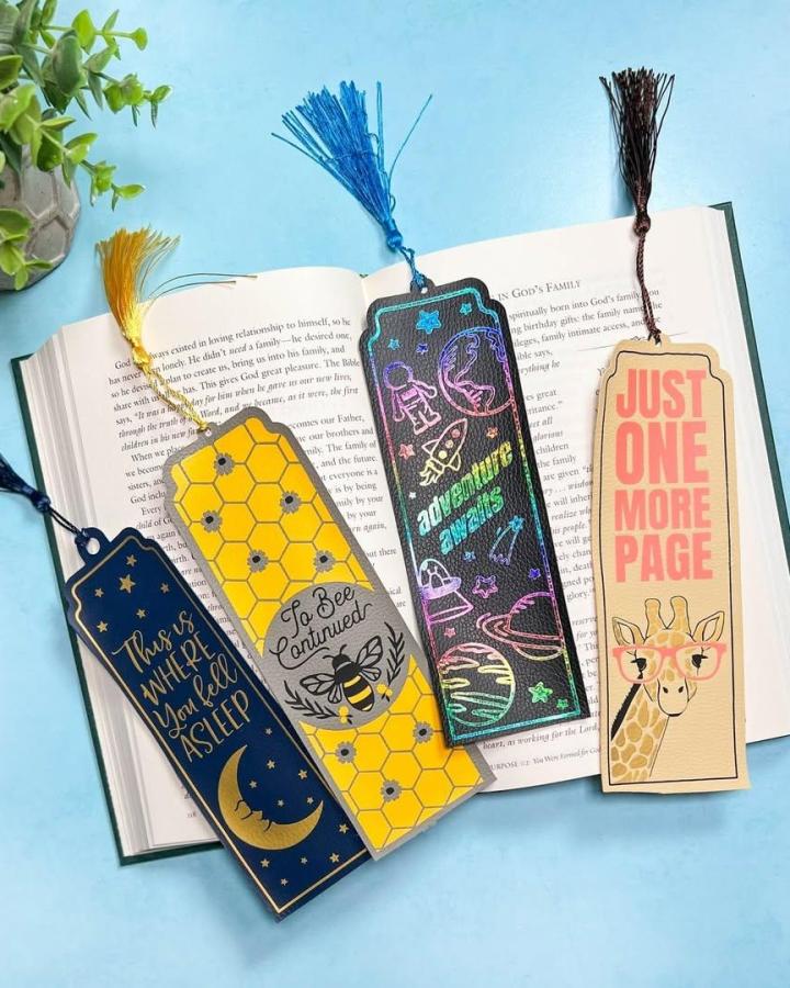 Yellow space and bee patterned faux leather bookmarks with tassels from @mybetterlifeblog. Colorful, playful reading accessories.