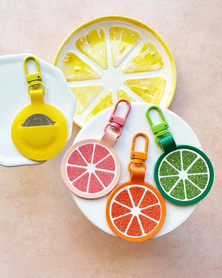 Bright colorful faux leather citrus coin pouch keychains from @amyromeucrafts with glitter accents for faux leather crafts.