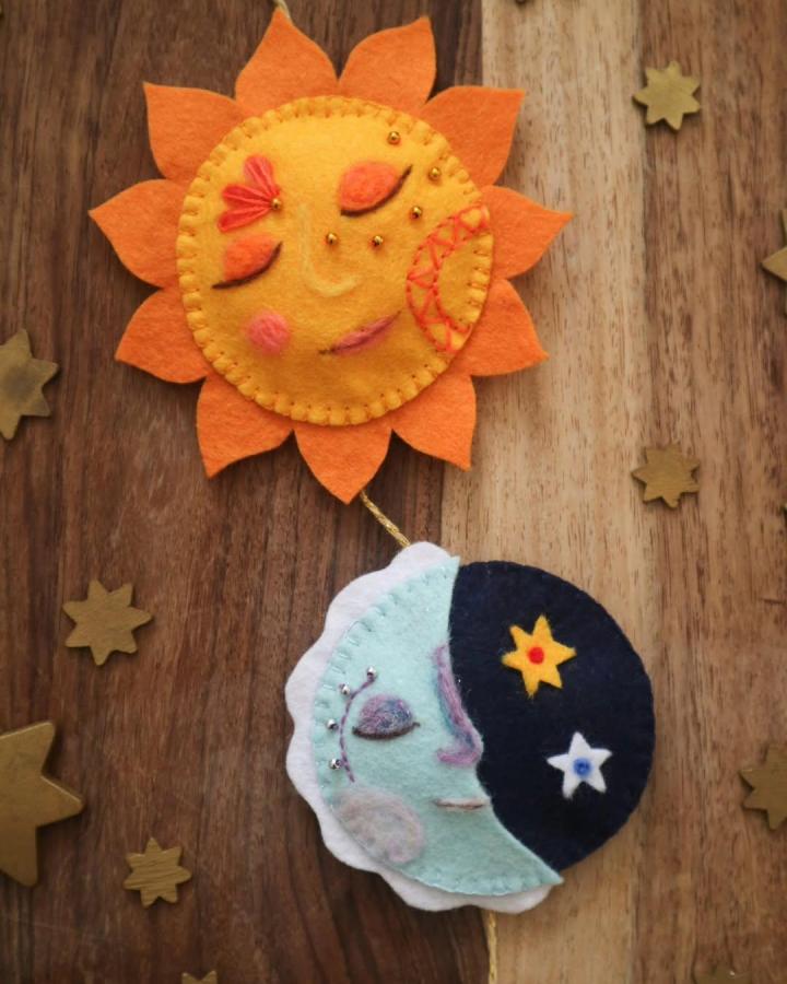 Orange sun and blue moon felt wall hanging with golden beads from @winterdragoncrafts. Cozy celestial decor idea.