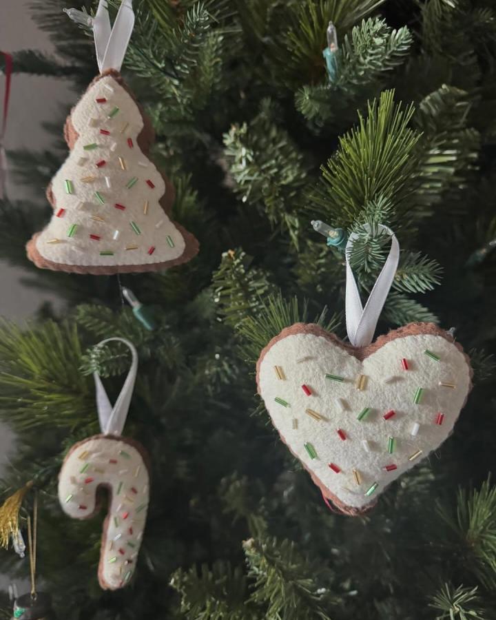 Cream and brown felt Christmas tree, heart, and candy cane ornaments with colorful bead accents by @caylinmiller showcasing unique felt ornament ideas. Soft, handmade holiday decorations.
