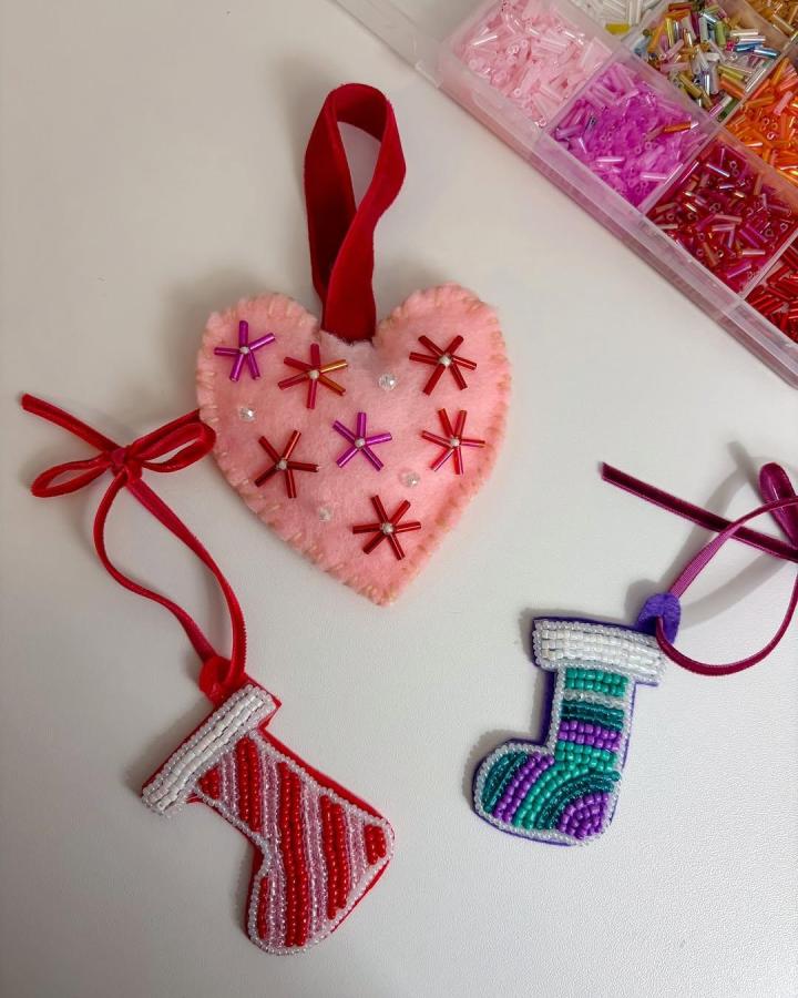 Pink heart-shaped felt ornament with red and pink beaded flowers and a red velvet hanging loop from @valley_view_creations_ handcrafted and cozy style.