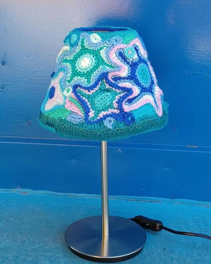 Colorful crochet lampshade with star motifs using mixed blues and pinks by @gracefully_grazia featuring 13 distinctive shapes and textures.