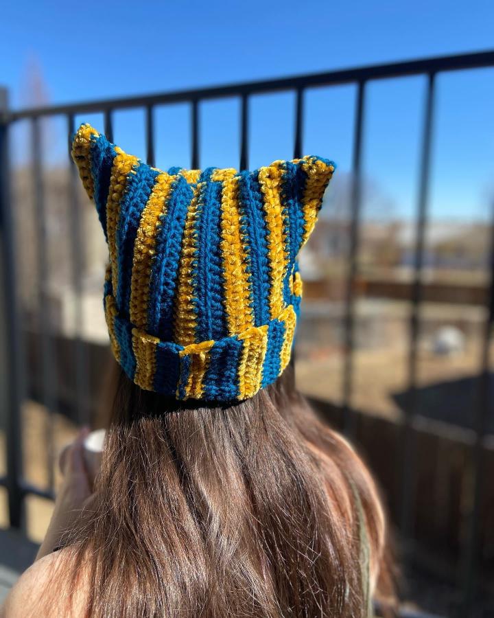 Striped blue and yellow crochet cat ear beanie by @theweavingwook bold textured playful handmade hat accessory.