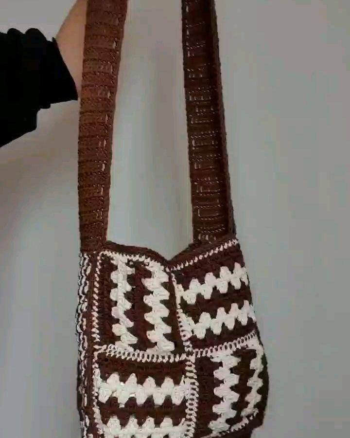 Brown and cream patchwork crochet bag from @justtheworsted showcasing funky crochet pattern ideas with chunky squares and textured strap.
