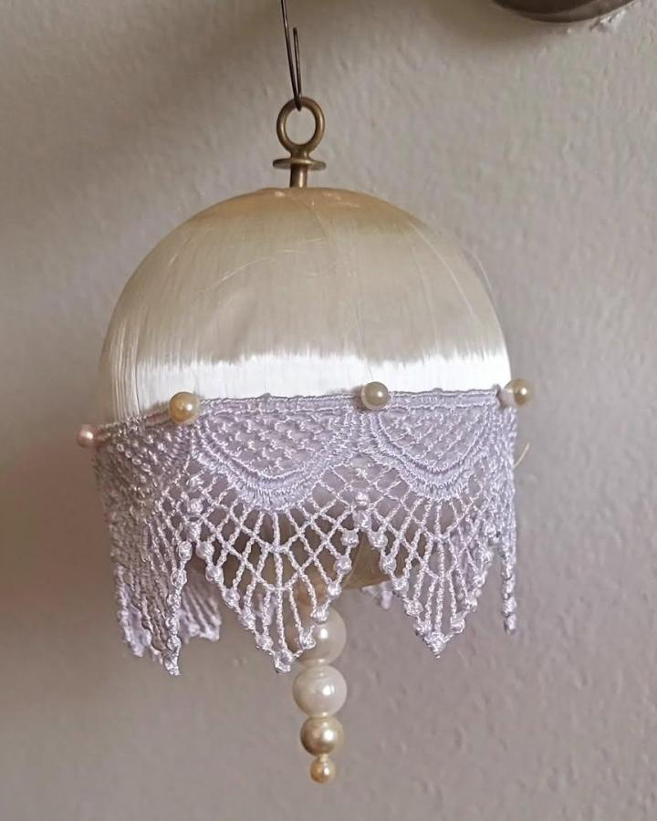 Cream satin and vintage lace beaded ornament from @princesspearlmermaid. Elegant handmade hanging craft with pearl accents.