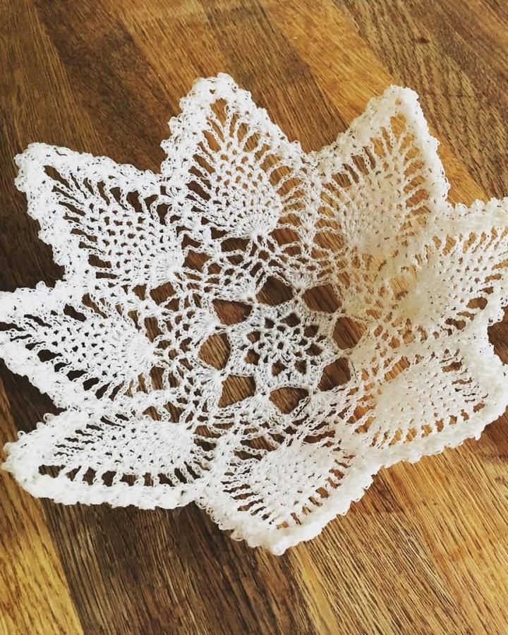White crochet lace trinket bowl from @vintage_rainb0w. Vintage-inspired fabric craft shaped into a star pattern for decorative use.