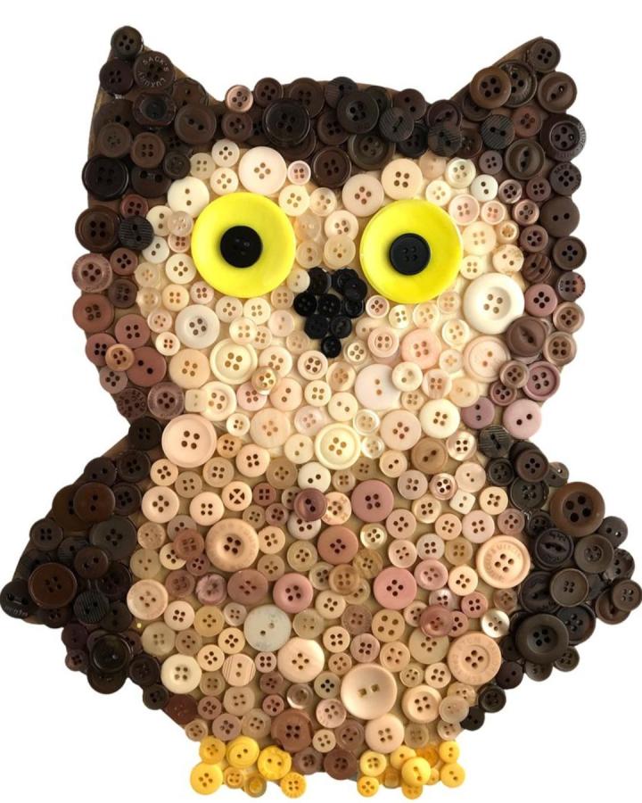 Brown and beige button owl craft with yellow eyes from @buttonsgalore showing detailed texture and color variation in owl crafts for adults.