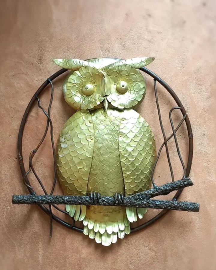 Golden metal owl wall art with textured branch details by @ashishghosh10 featuring layered scale-like feathers in a rustic circular frame for adult craft enthusiasts.