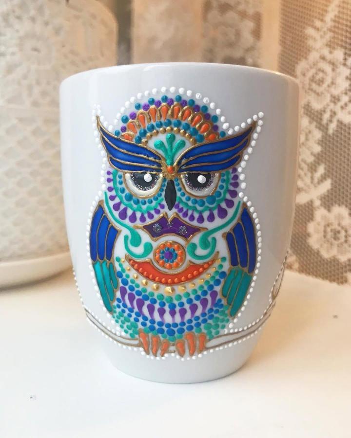 White ceramic mug with colorful dotted owl design by @ana_artstudio showing vivid ornamental details and gold outlines perfect for adult crafting projects