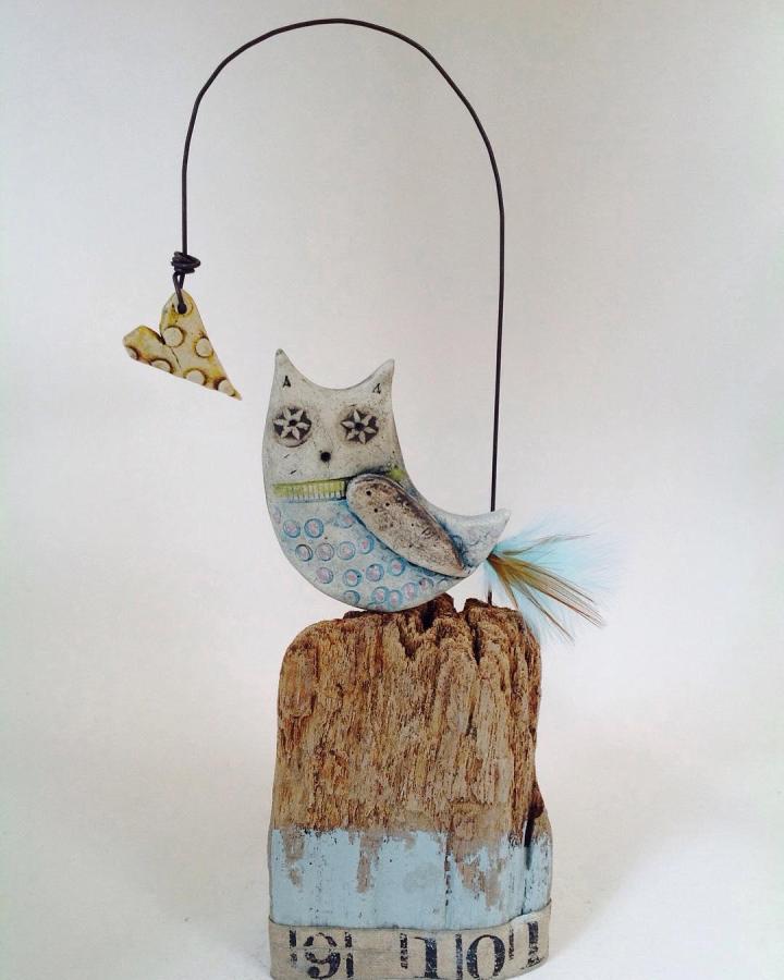 Rustic mixed media owl sculpture with feather tail and hanging heart detail by @shirleyvauvelle showcasing creative adult craft design.