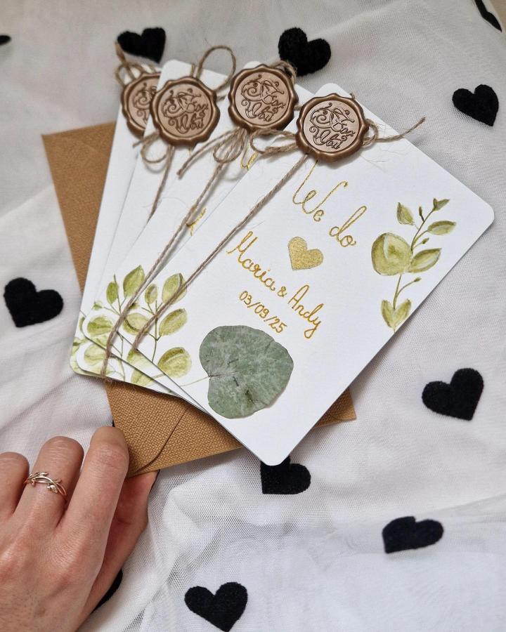 Natural green leaf accented wedding cards by @sunshine.artcrafts with twine and wax seal details on white cardstock.