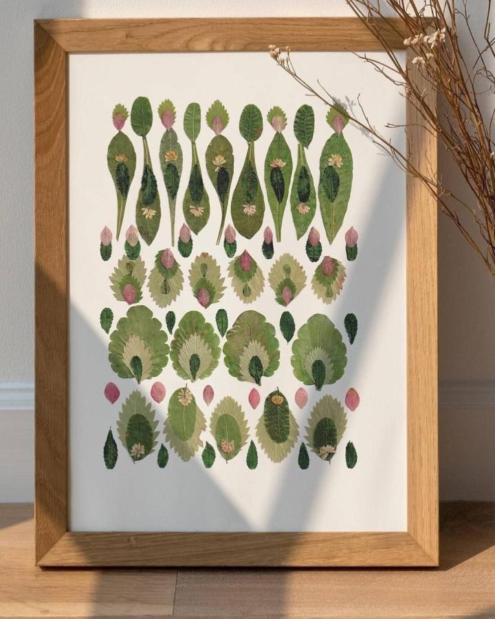 Green and pink patterned pressed leaf crafts framed artwork from @alinadecorshop. Natural textures highlighted in neat rows and soft floral accents.