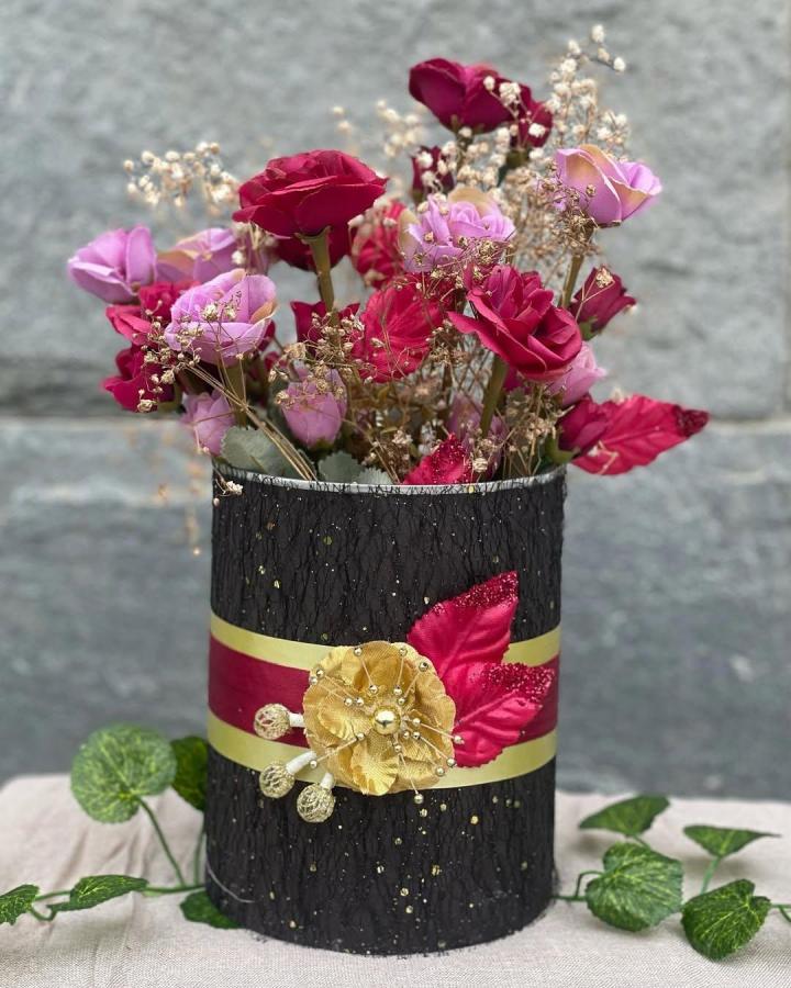 Elegant black and gold fabric decorated recycled container from @euphoriacreatives.co with faux floral arrangement and sparkling accents.