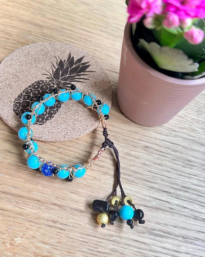 Turquoise and black bead wire wrapped bracelet with dangling charms by @bqueen4life showing creative wire jewelry ideas.