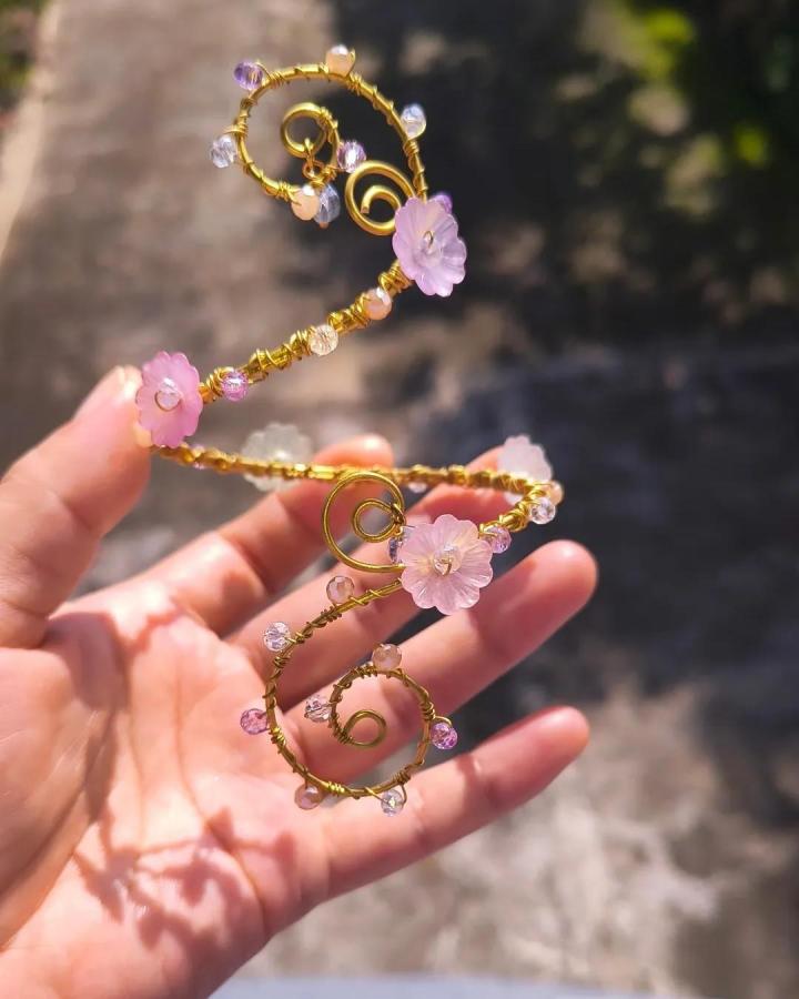 Pink and gold wire wrapped bracelet by @pixie_blooms___. Handmade fairy style with flower charms and crystal beads detail.