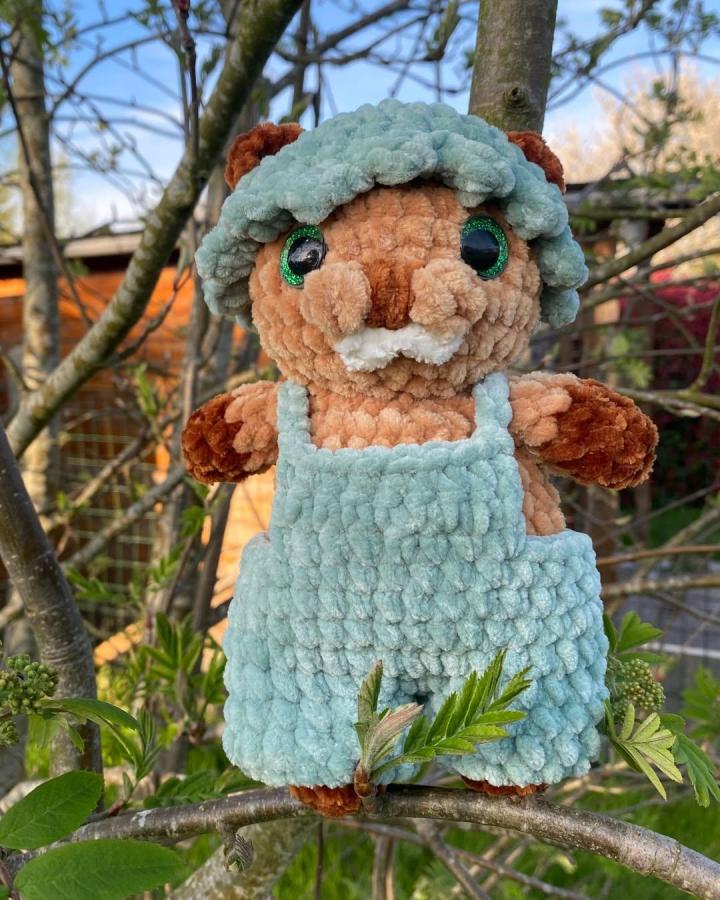 Fluffy teal and brown plush woodland crochet pattern ideas critter from @beingcreativewithdee with cozy outfit and detailed features.