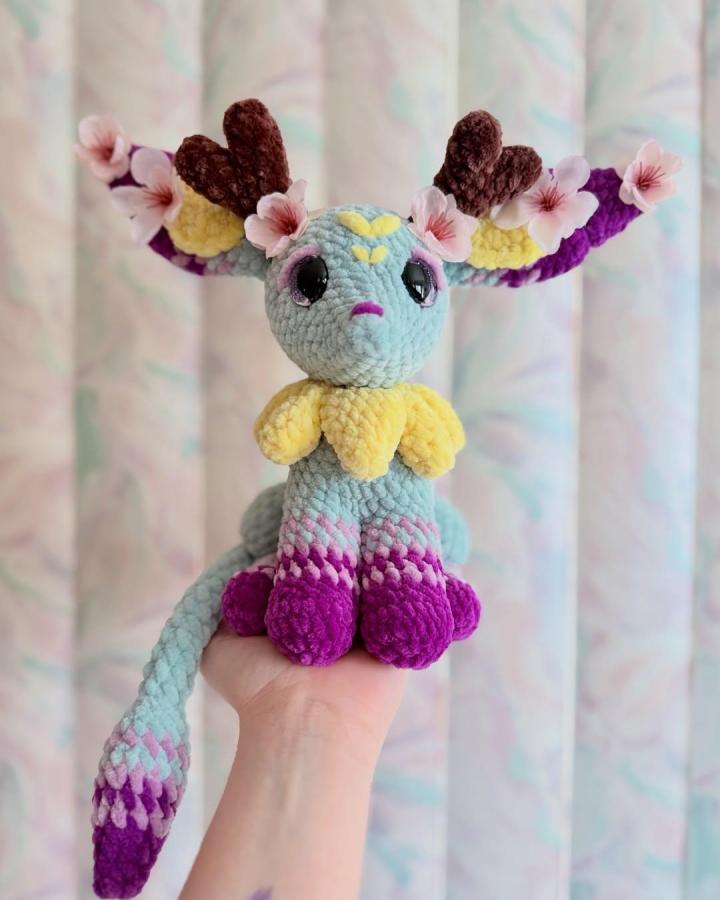 Light blue and purple plush crochet deer with floral accents from @kxt.crochet. Soft, whimsical forest creature plush.