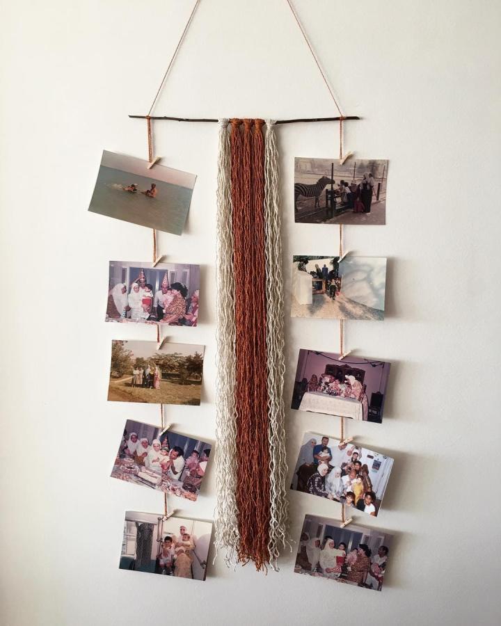 Creamy ivory and rusty orange yarn wall hanging with photos from @frolic.aa showing unique yarn wall hanging ideas for cozy decor.