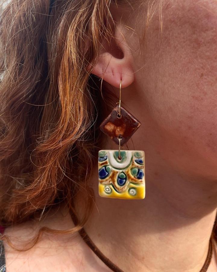 Brown and yellow glazed ceramic tile earrings from @iryna.vyshnyk showcasing creative ceramic tile crafts with hand-painted details.