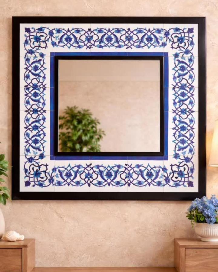 Elegant blue floral ceramic tile mirror frame by @desen_studio_. Hand-painted intricate ceramic tile crafts with indigo and navy details and black outlines.