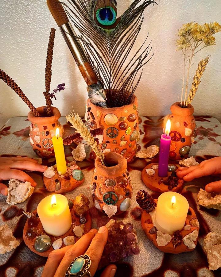 Terracotta boho candle holders with stones and shells by @cosmic_carmen featuring natural textures and warm earthy tones.