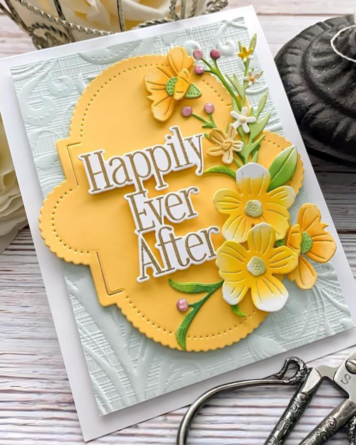 Yellow floral die cuts on textured white embossed card base by @kellylunceford. Bright and cheerful wedding invitation style with pearl accents.