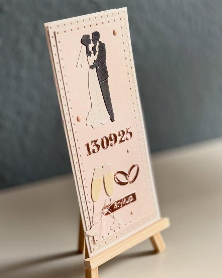 Blush pink wedding card with black silhouette and rose gold foil details from @tinnas_scrap_and_creative_room featuring romantic couple and champagne glasses.