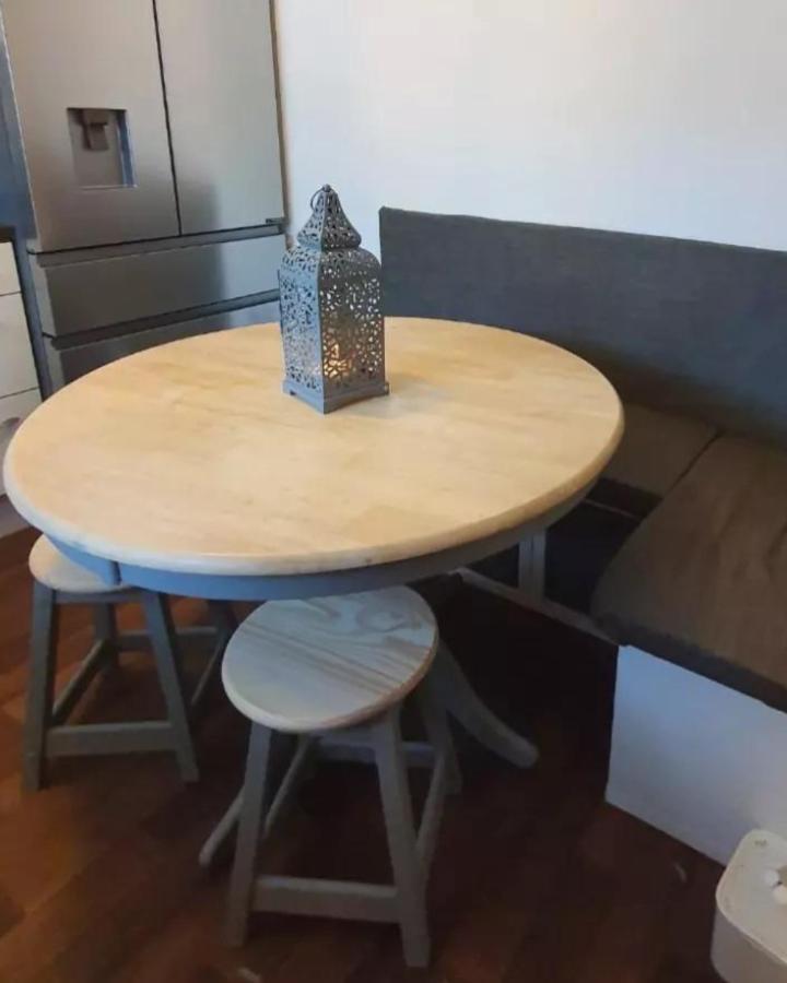Gray fabric padded dining bench made from upcycled Kallax unit by @lisa_gc_12 in a cozy kitchen nook. Comfortable and space-saving seating.