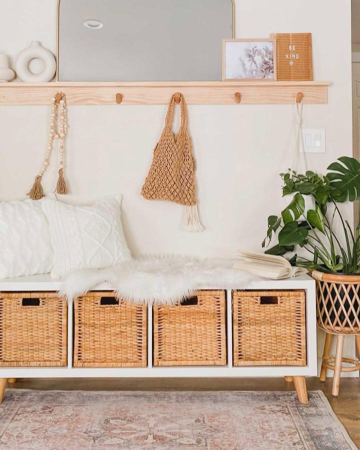 Natural rattan baskets and wooden leg ikea kallax bench ideas from @jcdesign1.1 with cozy white throw and neutral decor.