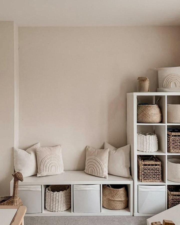 Cream and natural woven basket storage bench with soft cushions and fabric bins from @baba.na.zakupach showcasing ikea kallax bench ideas with cozy neutral tones and textures.