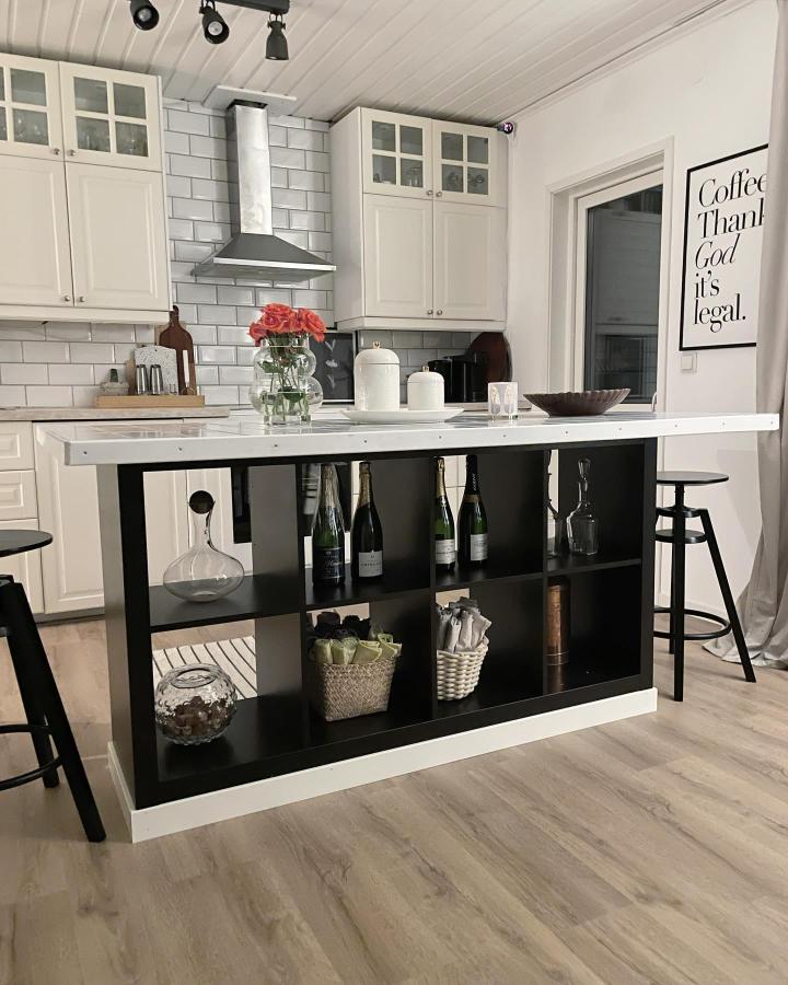 Black Ikea Kallax kitchen island from @kerstinredning with wine storage and white countertop ikea kallax hacks. Modern and functional design.