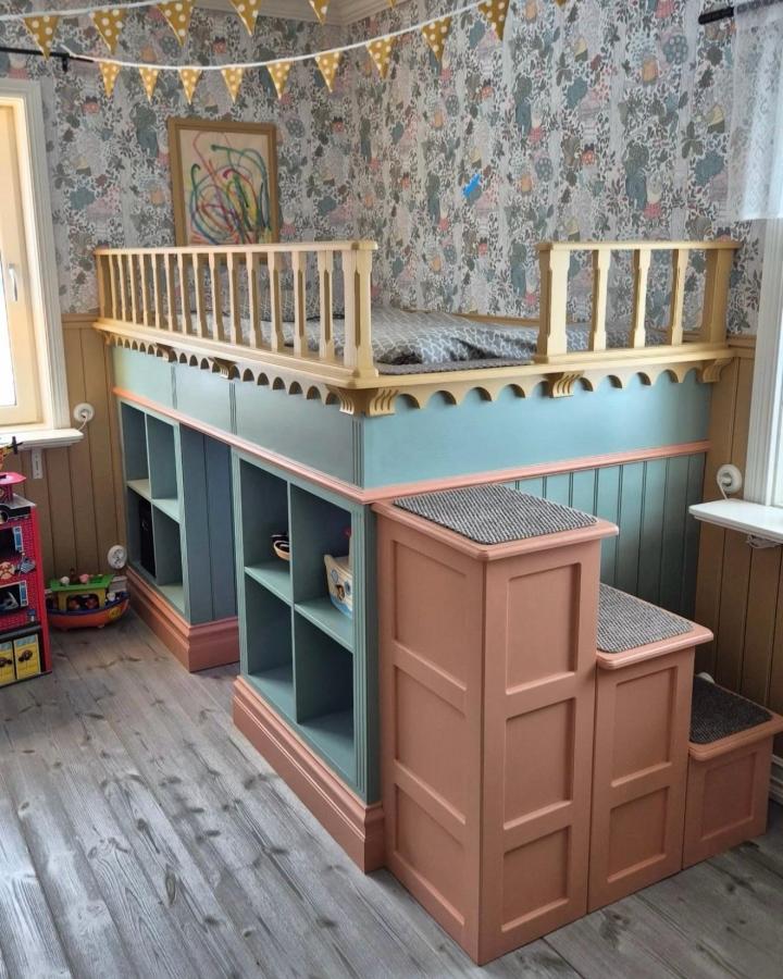 Blue and pink painted Kallax storage unit transformed into loft bed with stairs carpeted by @playfulrooms. Children's bedroom setup with smart storage and creative design.