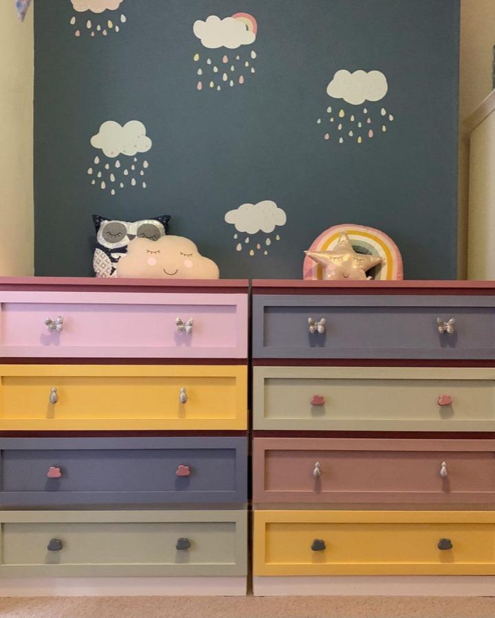 Pastel painted wooden dresser drawers with playful cloud and pineapple knobs in kids room by @renovating_no.2 bright and colorful customization.